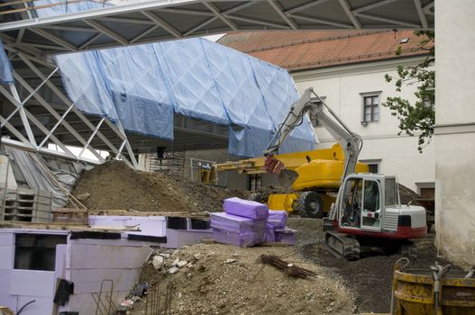 Digger on construction site, moving earth