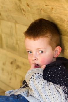 Depressed young boy looking directly ahead