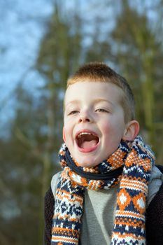 happy young boy playing outdoors