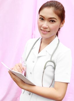 Asian female nurse writing medical report