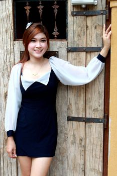 Beautiful young  woman near old wooden door