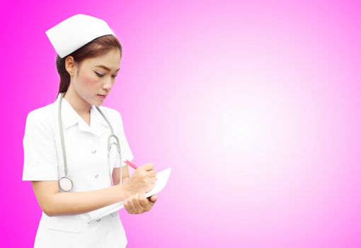 Asian female nurse writing medical report on pink background