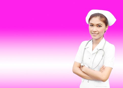 Female nurse standing with stethoscope on pink background