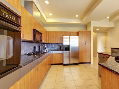 Large modern wood kitchen with living room and high ceiling and ivory walls.