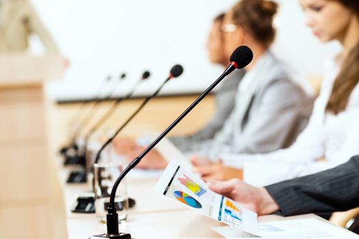 close-up microphone, on the background of business communication at the conference