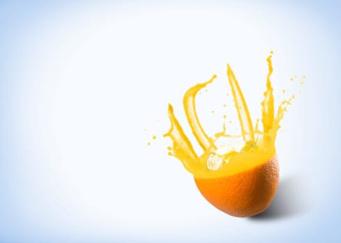 ice cubes fall into the orange, spray and splashes of juice