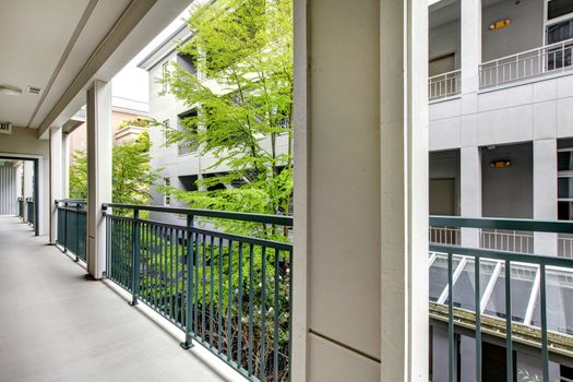 Apartment balcony with modern building court yard.