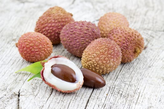 fresh lychees on wooden background