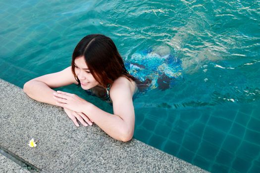 Woman at the Edge of a Swimming Pool