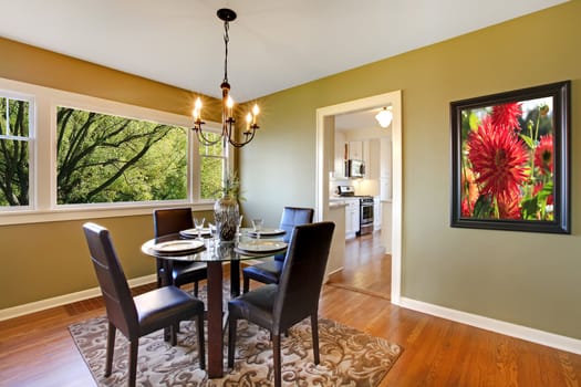 Fresh green dining room with art.