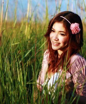 Portrait of beautiful young Asian girl in the grass