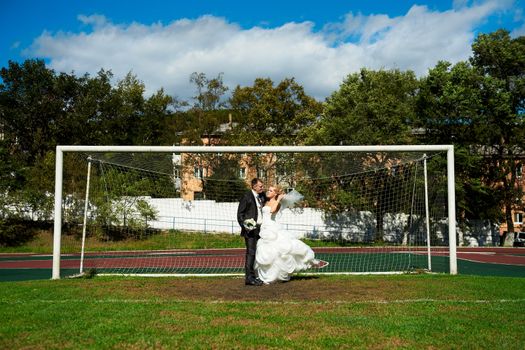 Bride and groom on the football field