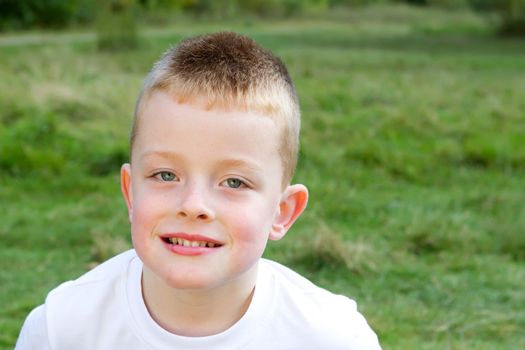 little boy smiling in the evening Autumn sun