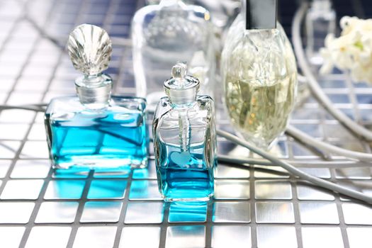 Perfume with beautiful flowers on the table