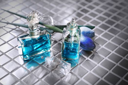 Perfume with beautiful flowers on the table