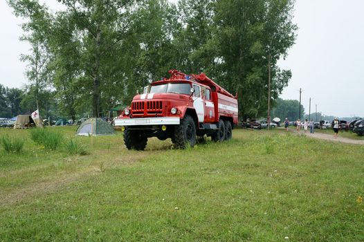 Duty fire truck in a camp in the summer day.