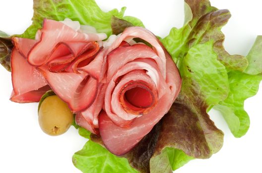 Arrangement of Jamon and Greens with Olive closeup on white background. Top View