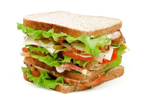Turkey Meat Tasty Sandwich with Cheese, Tomato, Marinated  Gherkins and Lettuce on Whole Wheat Bread closeup isolated on white background