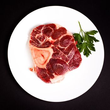 Beef with bone on white plate