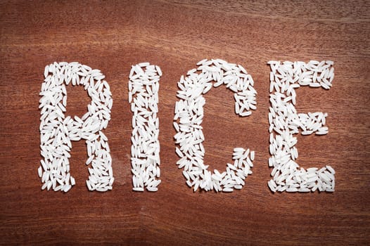 the word "rice"  on a wooden surface.