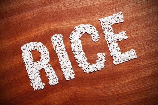 the word "rice"  on a wooden surface.