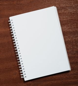 Notebook on wooden background. 