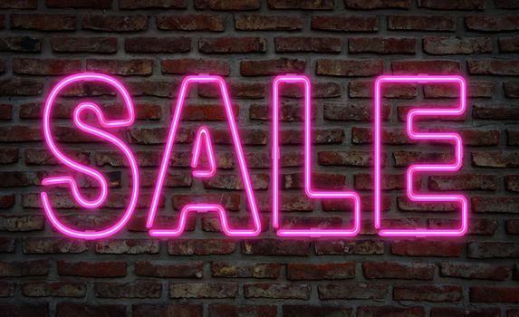 Glowing neon sale sing on a brick wall.