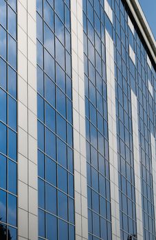 Blue sky reflected in the windows of office building