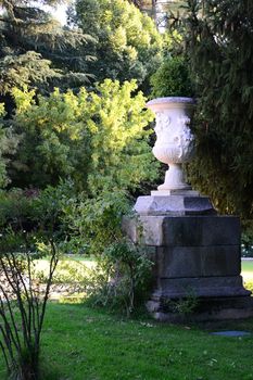Big vase into green trees. Monument in Campo de moro in Madrid