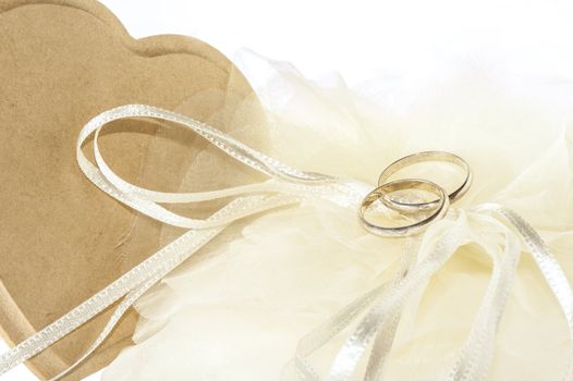 wedding favors and wedding rings on white background