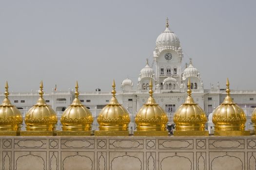 Golden Temple. Holiest shrine of the Sikh religion. Row of gold domes along the roof of the temple. Amritsar, Punjab, India.
