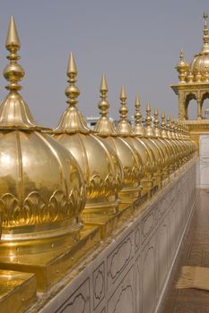 Golden Temple. Holiest shrine of the Sikh religion. Row of gold domes along the roof of the temple. Amritsar, Punjab, India.