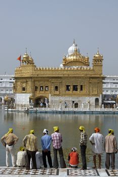 Group of people looking at the Golden Temple in Amritsar, Punjab, India