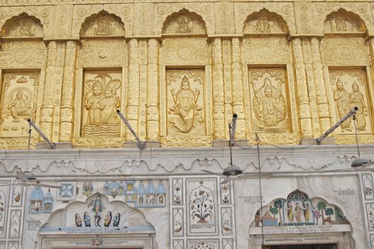 Durgiana Hindu Temple. Detail of ornate gold panel and inlaid mable decorating the front of a hindu temple. Amritsar, Punjab, India