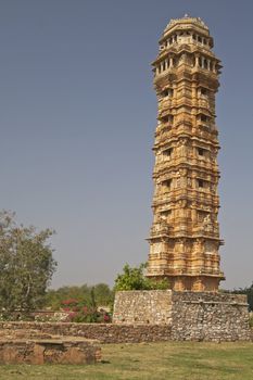 Ornate carved stone victory tower (Vijay Stambha) built to celebrate an ancient victory. Chittaugarh, Rajasthan, India.