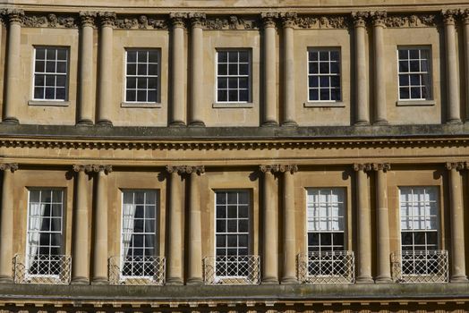 Windows in a curved terrace of Georgian Town houses in The Circus, Bath, England