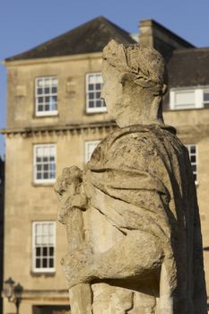 Weathered statue of a Roman soldier at the ancient Roman Baths in Bath, Somerset. England.