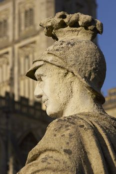 Weathered statue of a Roman soldier at the ancient Roman Baths in Bath, Somerset. England.