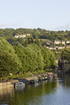 Canal boats moored on the River Avon in the centre of the historic city of Bath in Somerset, England