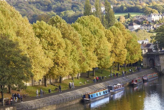 Canal boats moored on the River Avon in the center of the historic city of Bath in Somerset, England