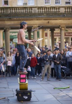 Street artist juggling with knives in Abbey Churchyard, Bath, Somerset, England