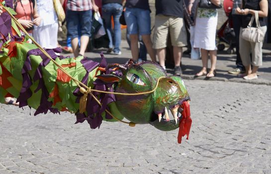 Street artists re-enacting the story of St George and the dragon in Bath, Somerset, England as part of the St Georges Day celebrations.