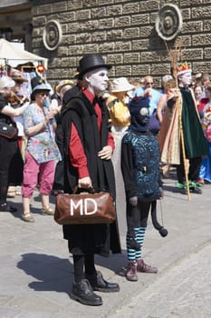 Street artists re-enacting the story of St George and the dragon in Bath, Somerset, England as part of the St Georges Day celebrations.