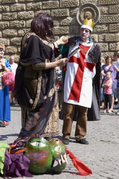 Street artists re-enacting the story of St George and the dragon in Bath, Somerset, England as part of the St Georges Day celebrations.