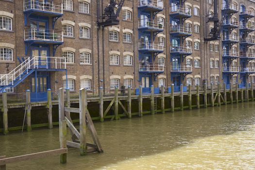 Historic old warehouse now converted into homes in the docklands area of London, England.