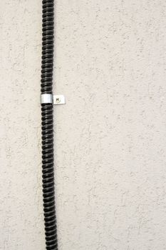 cable mounted on wall on a facade