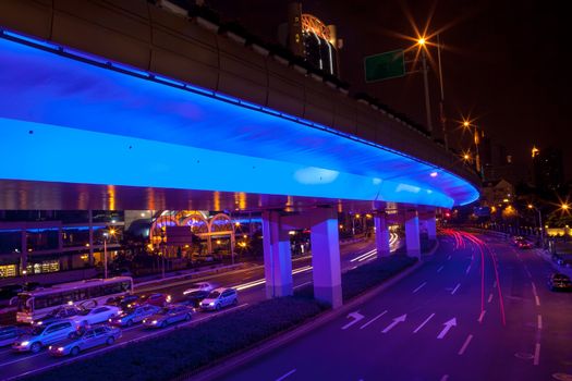 Blue Highway Street Traffic Cars and Light Trails at Night in Central Shanghai, China.