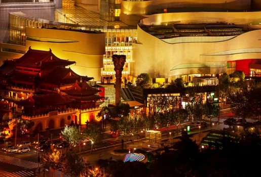 Golden Temples Roof Top Jing An Tranquility Temple Park at Nanjing Street Cars and Intersection in Central Shanghai, China. Richest buddhist temple in Shanghai.  