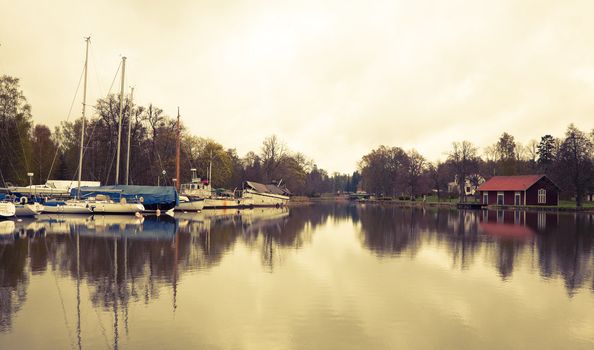 Tranquil scenery from the Gota Canal Sweden. Cross processed to give a retro look. Space for text.
