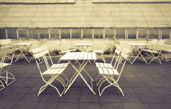 Old greenhouse and garden furniture Sweden. Cross processed to underline the retro look.